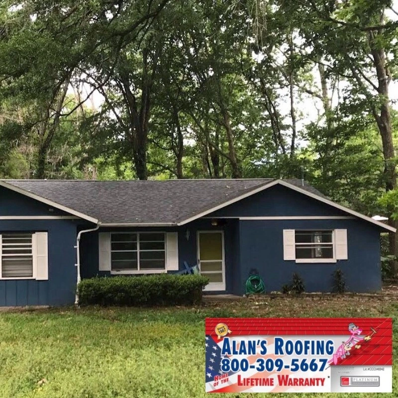 Roof Replacement on a blue home installe by the local roofing company; Alan's Roofing.