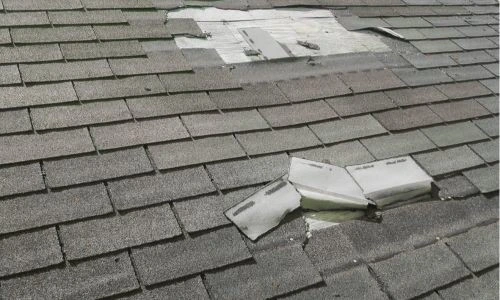 Damaged asphalt shingles on a residential home 