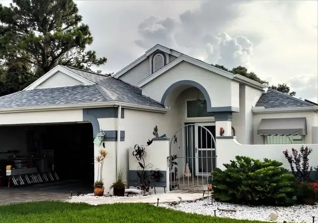 A Florida home featuring a newly completed residential roof replacement with updated shingle roofing and fresh curb appeal.