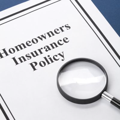 homeowners insurance policy with magnifying glass