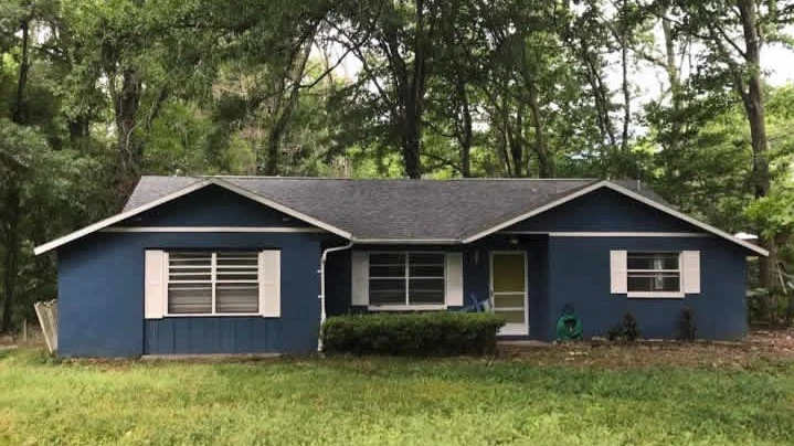 Blue residential home in Brooksville with new roof replacement