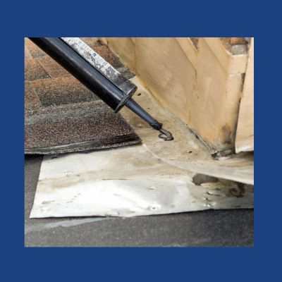 Deteriorated roof flashing at wall junction showing signs of water damage and failed sealant requiring professional repair