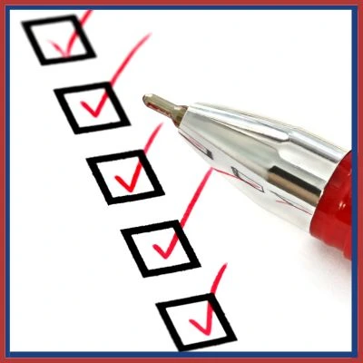 A close-up of a red pen marking checkboxes on a checklist, symbolizing task completion and inspection processes.